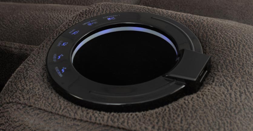 Close up image of an electric cupholder on a lounge suite armrest